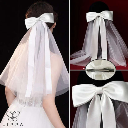 Ivory satin bridal bow veil headdress with a delicate tulle veil, perfect for weddings and special occasions. Lightweight and elegant wedding hair accessory