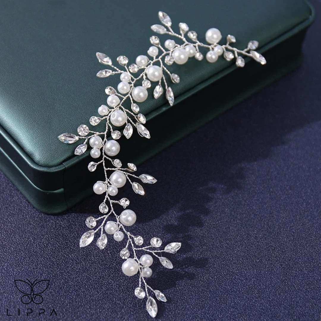 Close-up of a handmade pearl and crystal wedding hair vine featuring delicate floral and leaf motifs, perfect for bridal and formal hairstyles