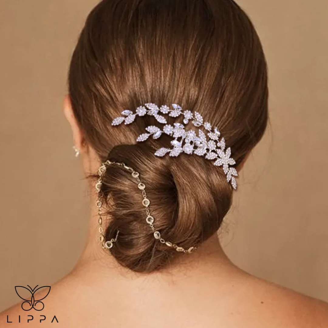 Elegant bridal hair comb with rhinestone-encrusted leaf and floral design, perfect for weddings and formal events. Lightweight, secure, and timelessly stylish